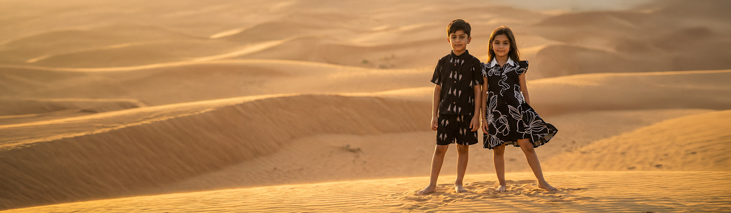 Kids in the desert at sunset